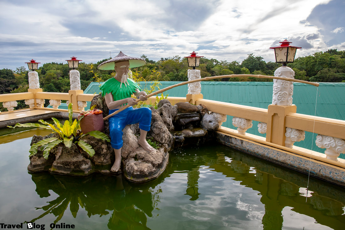 Cebu Taoist Temple, Fisherman in the pond, Cebu City, Philippines © travelblogonline.com