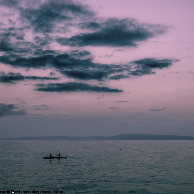 The boulevard, Two men in a boat, Dumaguete, Philippines © Patrik Lord Travel Blog