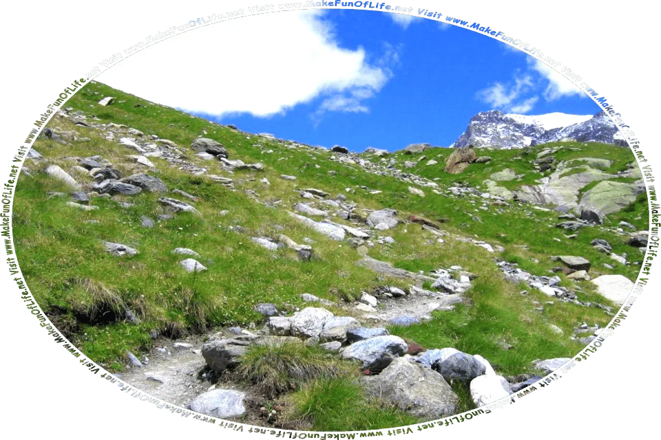 Picture of a rock-strewn dirt footpath leading up a hillside that is covered with green grass, a blue sky with fluffy white clouds above, and the words, Visit www.MakeFunOfLife.net.