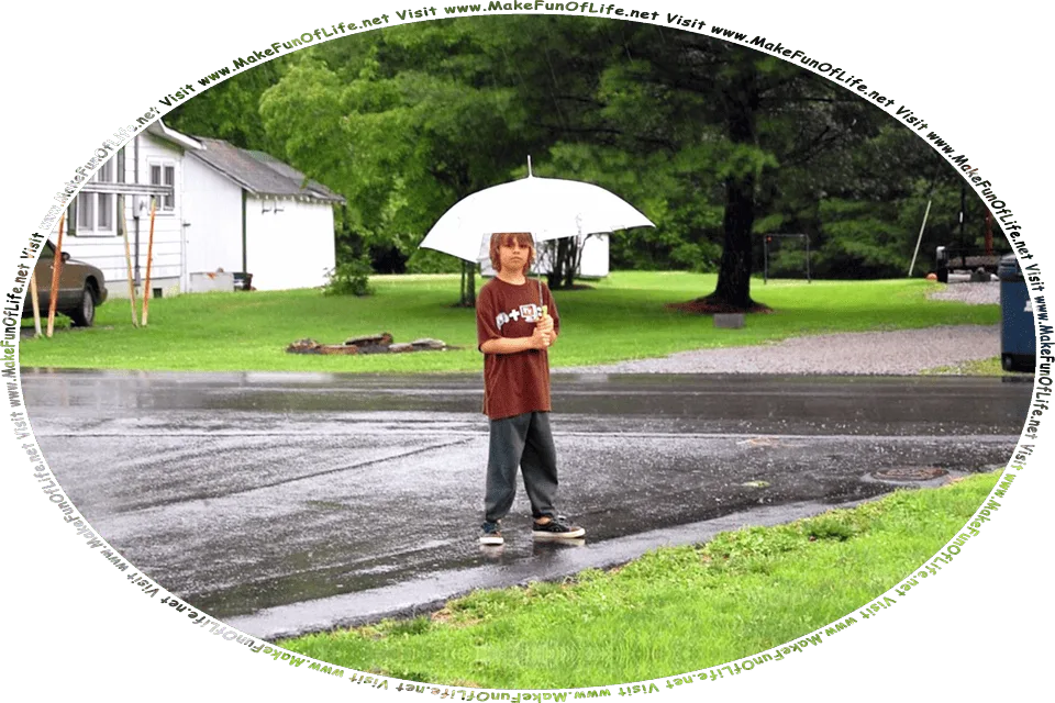 Picture of a boy holding an open umbrella above his head and standing outside of a house on a rainy day, surrounded by green grass and green leafy trees, and the words, Visit www.MakeFunOfLife.net.