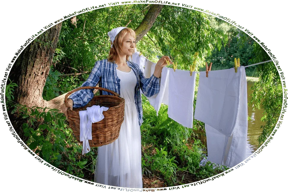 Picture of a woman standing under green leafy trees by a river, removing linens from a clothesline and placing them in a wicker basket, and the words, Visit www.MakeFunOfLife.net.