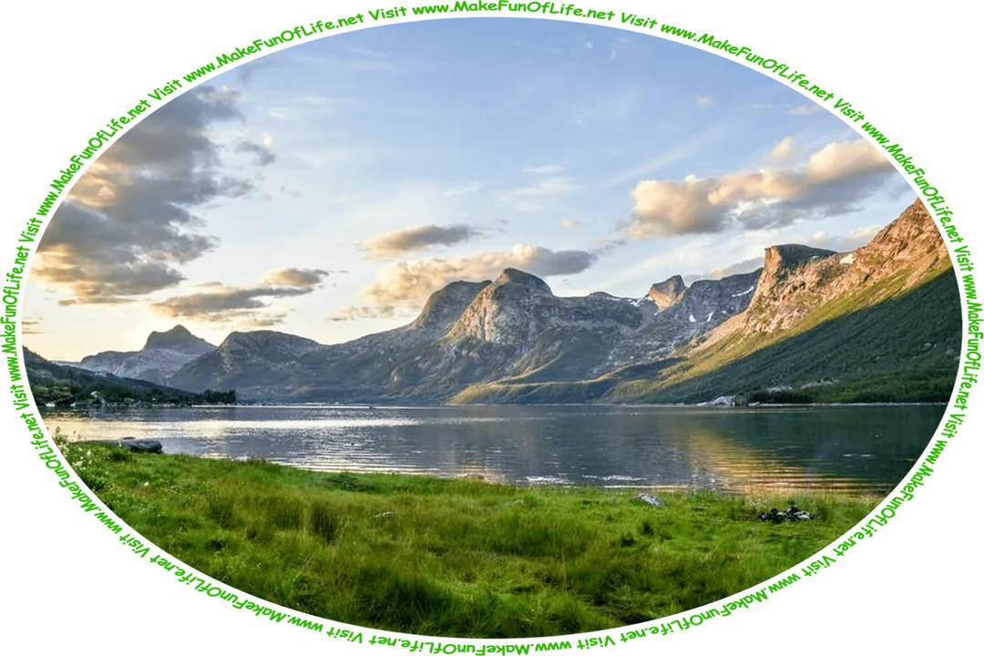Picture of a calm lake with short green grass on one side and steep mountains on the other side, a cloudy sky above, and the words, ‘Visit www.MakeFunOfLife.net.’