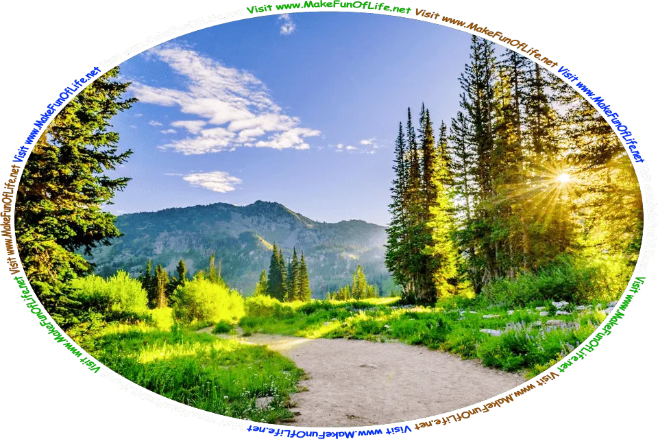Photograph of a footpath through a wilderness area, with evergreen trees and grass and flowering plants, the sun shining brightly in a blue sky with a smattering of white fluffy clouds floating over mountains in the background, and the words, ‘Visit www.MakeFunOfLife.net.’