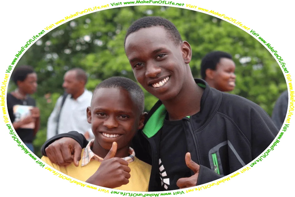 Picture of two happy smiling young men friends standing side-by-side, giving a thumbs-up hand gesture, as a family gathering is happening in the background, and the words, ‘Visit www.MakeFunOfLife.net.’