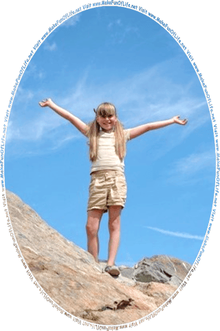 Picture of a happy smiling girl standing on top of large rocks under a clear blue sky, and the words, Visit www dot Make Fun Of Life dot net.