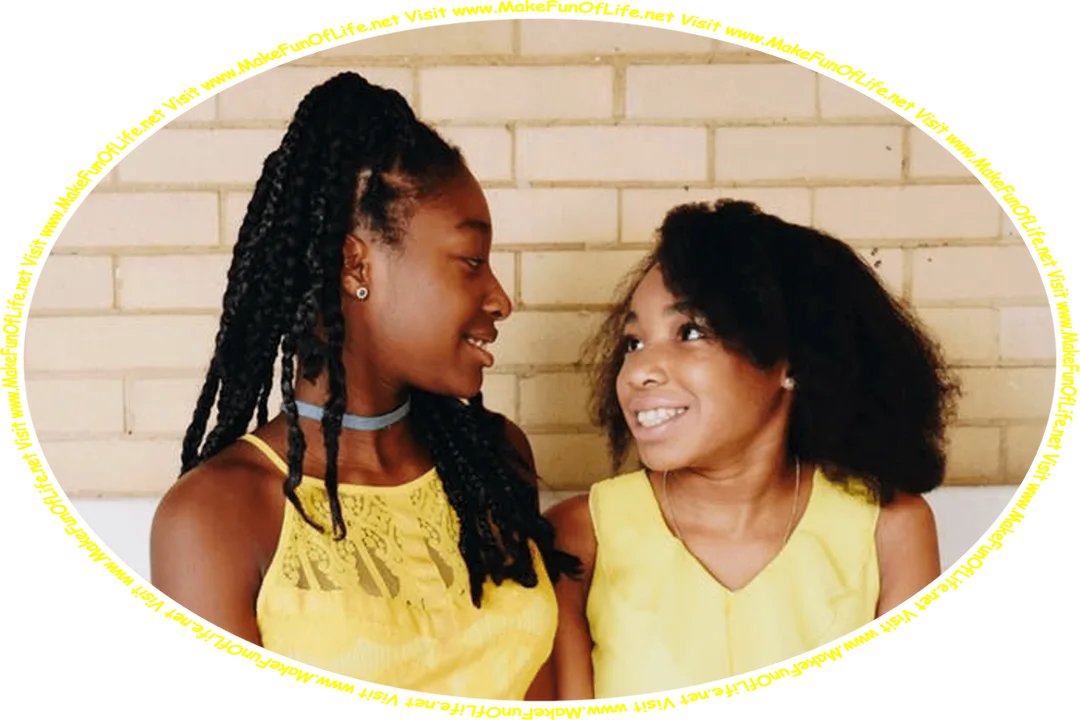 Picture of two happy smiling girls, who are friends, sitting on a wooden bench and talking, and the words, ‘Visit www.MakeFunOfLife.net.’