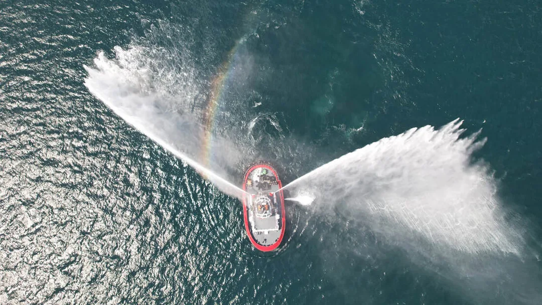 Marine firefighting vessel operating high-capacity water monitors at sea.Picture