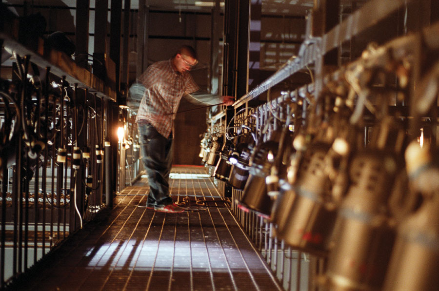 A lighting designer adjusts lighting instruments.