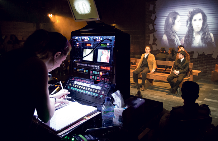 A stage manager calls cues during a perfromance.