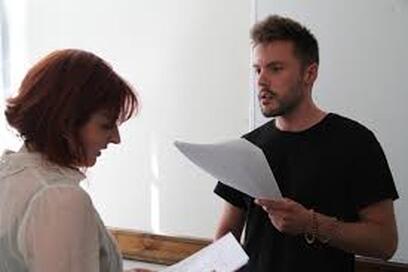 An actor works on a scene with a partner.