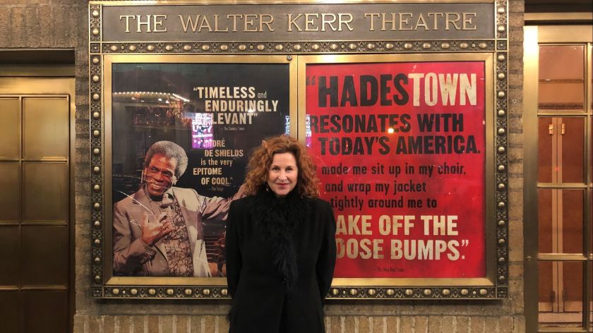 A theatre producer stands outside a theatre housing her show.
