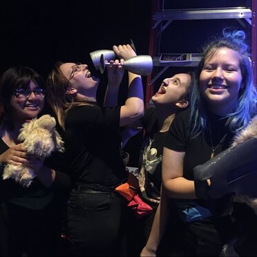 Technical crew members backstage with show props.