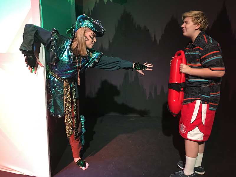Theatre 2 students perform a play dressed in costumes. 