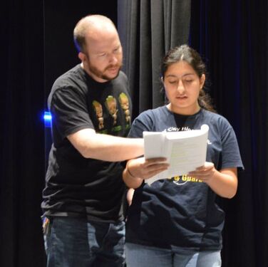 Mr. Hanks with a high school performer.