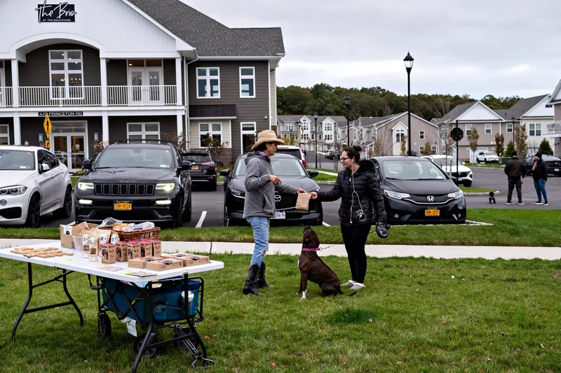 photo of people and dogs enjoying a Halloween dog costume parade