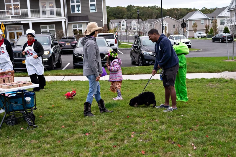photo of people and dogs enjoying a Halloween dog costume parade