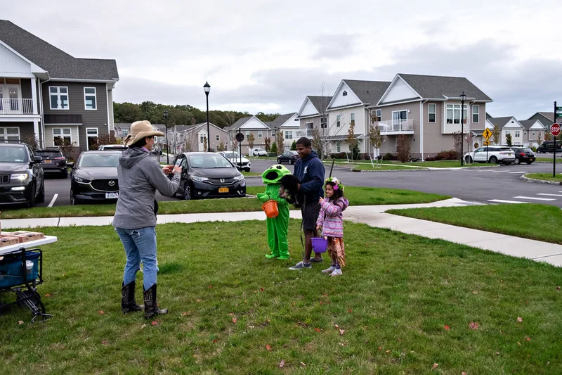 photo of people and dogs enjoying a Halloween dog costume parade