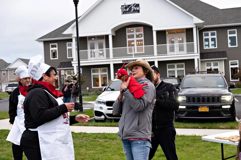 photo of people and dogs enjoying a Halloween dog costume parade