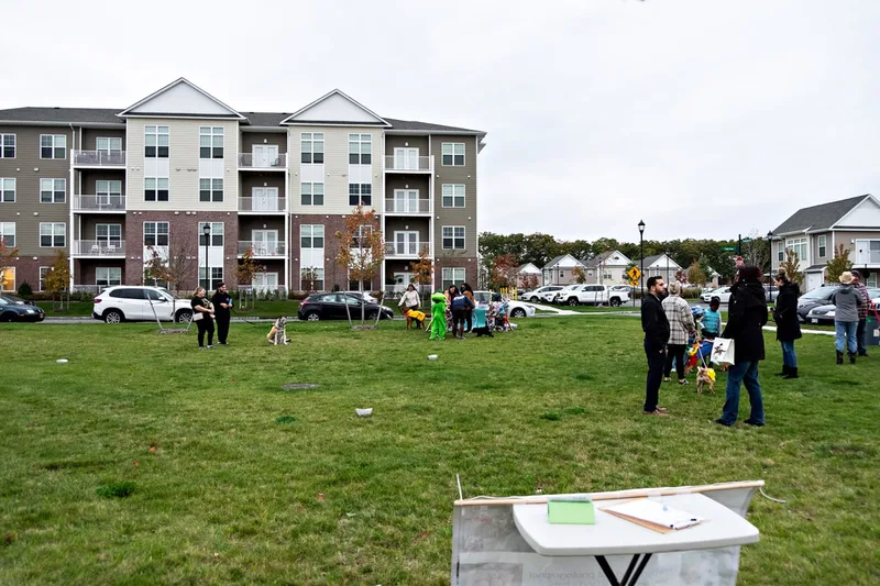 photo of people and dogs enjoying a Halloween dog costume parade