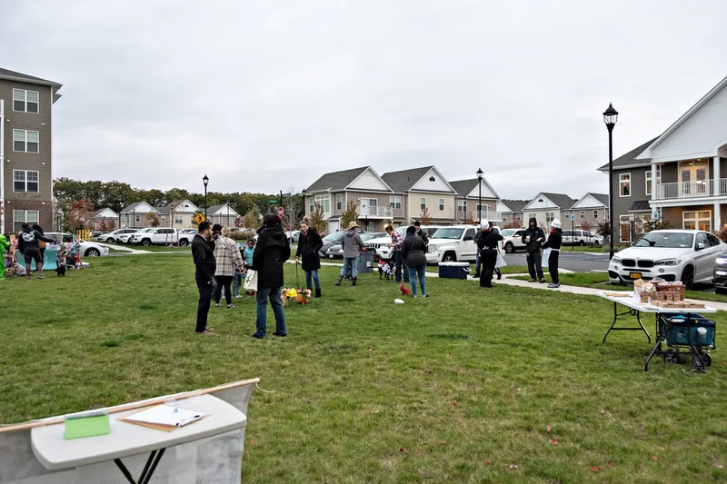 photo of people and dogs enjoying a Halloween dog costume parade