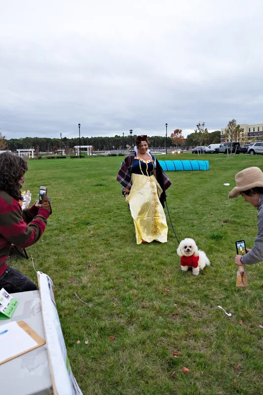 photo of a dog and his owner dressed as Snow White and an apple
