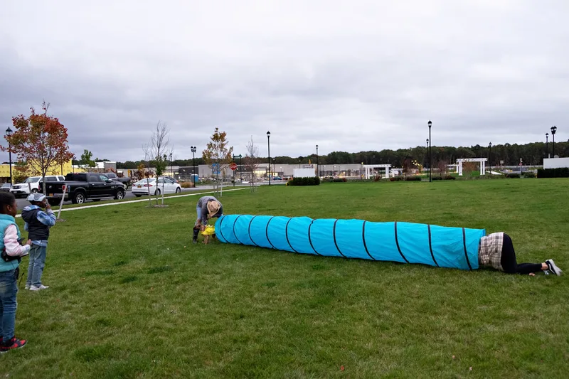 photo of people and dogs enjoying a Halloween dog costume parade