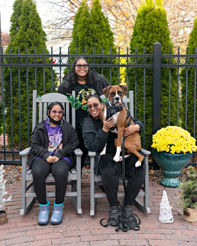 photo of a family with their boxer dog