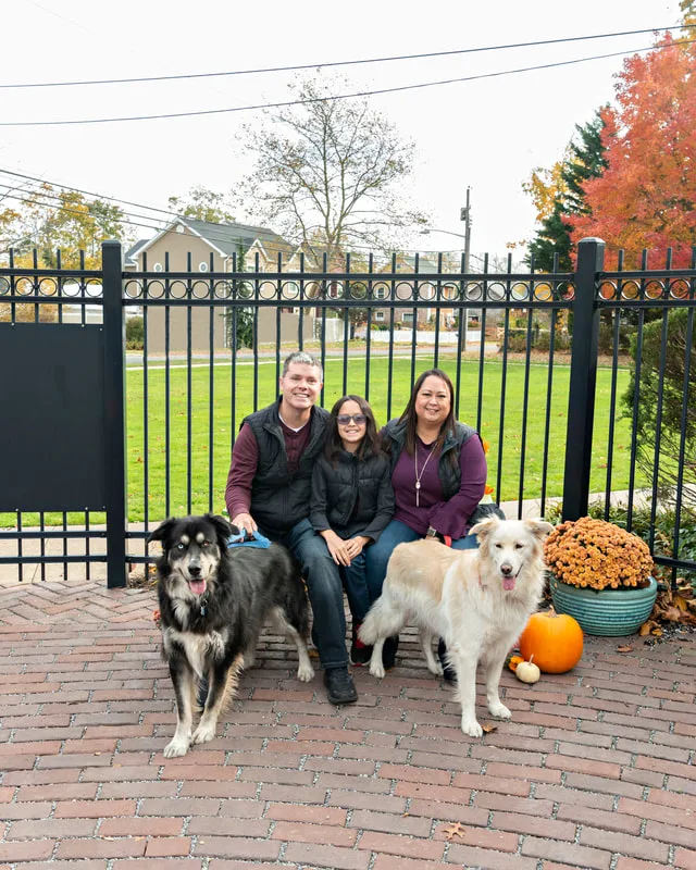 photo of a family with their husky golden mix dogs