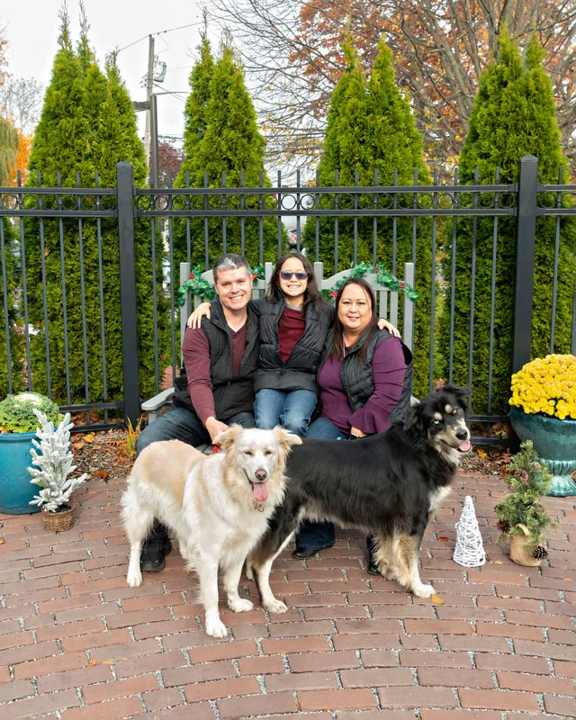 photo of a family with their husky golden mix dogs