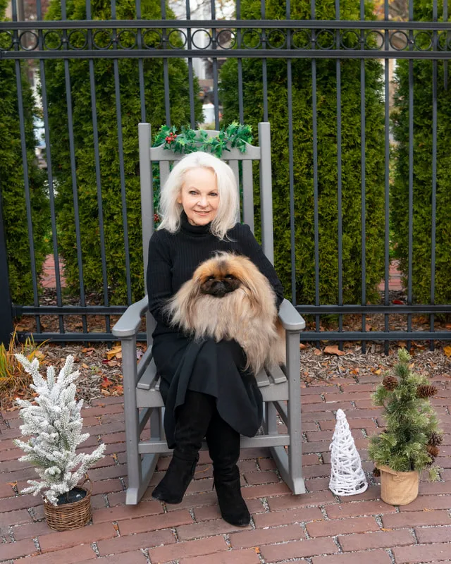 photo of a pekingese with her owner