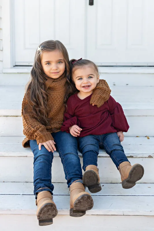 photo of two young sisters siting on steps
