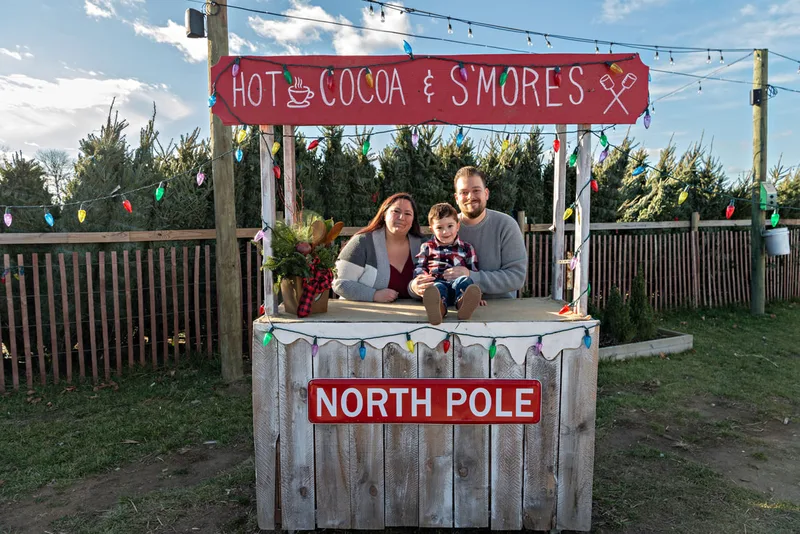 photo of a mom, dad, and son at the Waterdrinker Family Farm Winter Wonderland Festival