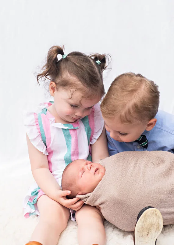 photo of toddler twins, a boy and a girl, and a newborn baby boy