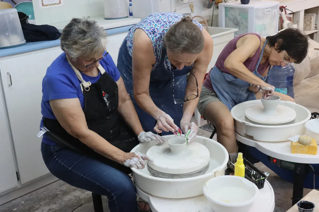Potters practice wheel throwing with porcelain during a small-group hands-on workshop in Antoinette Badenhorst's Saltillo, Mississippi studio.