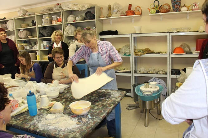 Antoinette Badenhorst throwing a porcelain slab to create handbuilt bowls similar to forms made on the potter’s wheel.