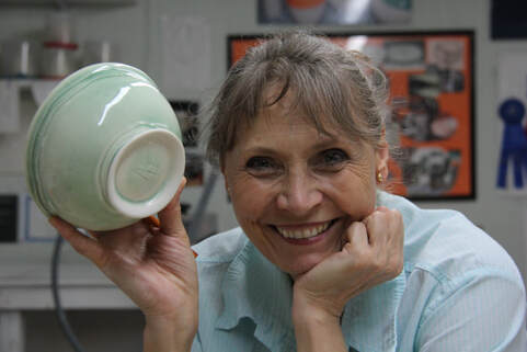 Antoinette Badenhorst shows a green porcelain bowl that she made during her wheel-thrown porcelain dinnerware online workshop. Glazing and firing porcelain is included in the class.