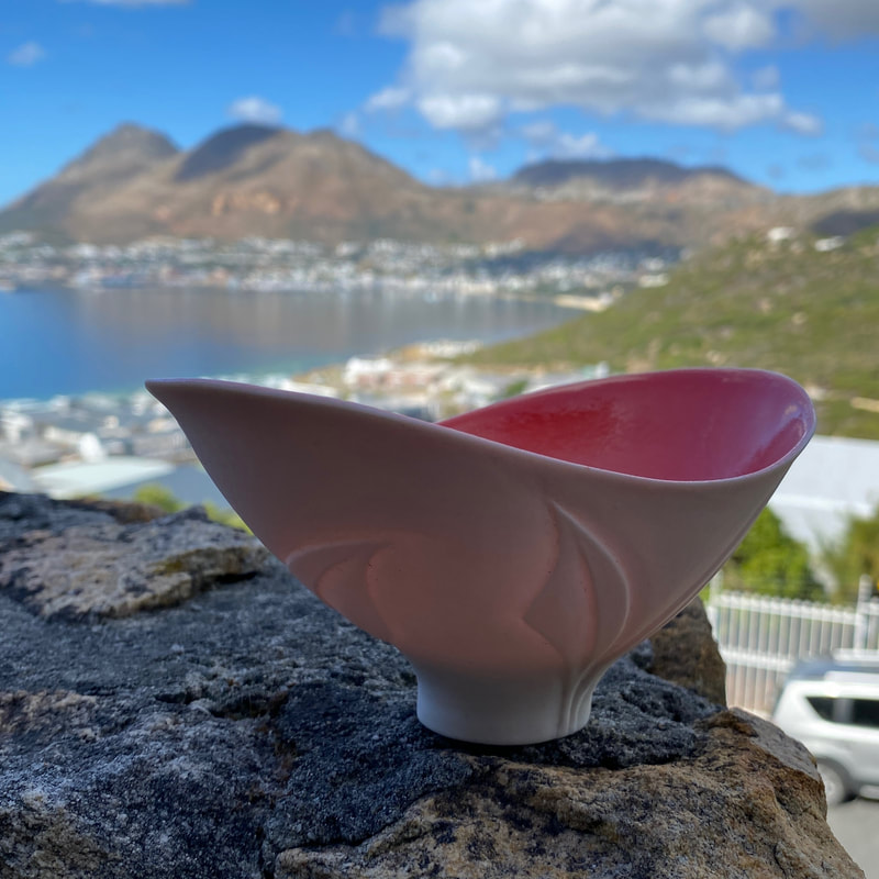 This is a hand-built, altered porcelain bowl by South African ceramic artist Antoinette Badenhorst.  The artist specializes in translucent porcelain pieces, often featuring carved exteriors and glazed interiors, which form part of her signature work. Each piece is part of a larger theme of 