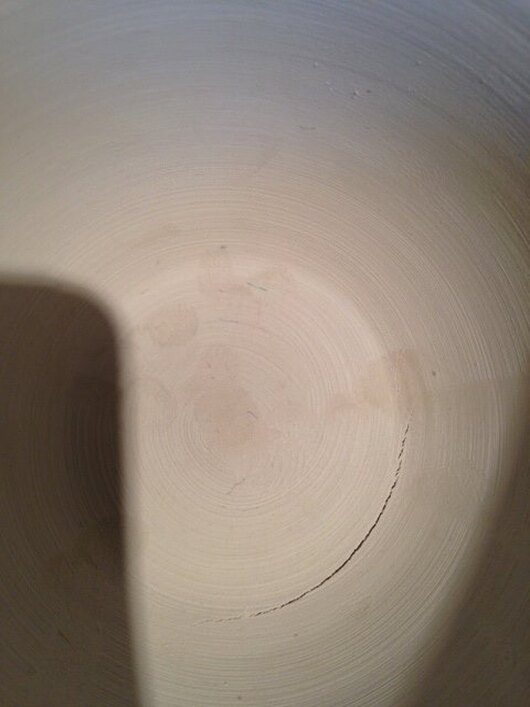 A crack showing on the inside of a dried bowl.