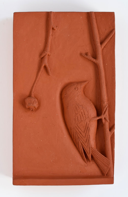 ceramic relief of songbird