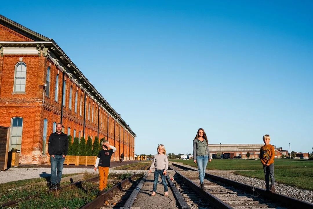 a woman walking along the rail platform next to the CASO Station