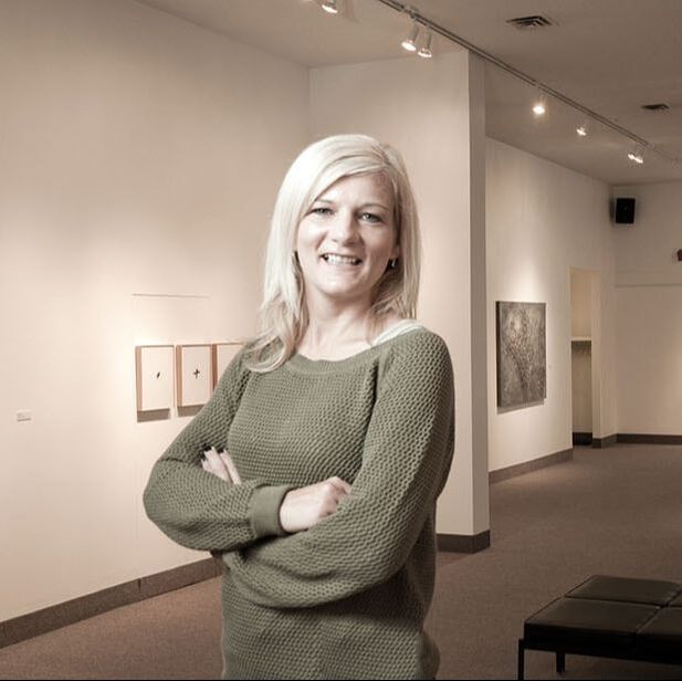 Laura Woermke - ED of the St. Thomas Elgin Public Art Centre standing in the gallery space 