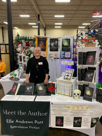 Elle standing behind table display