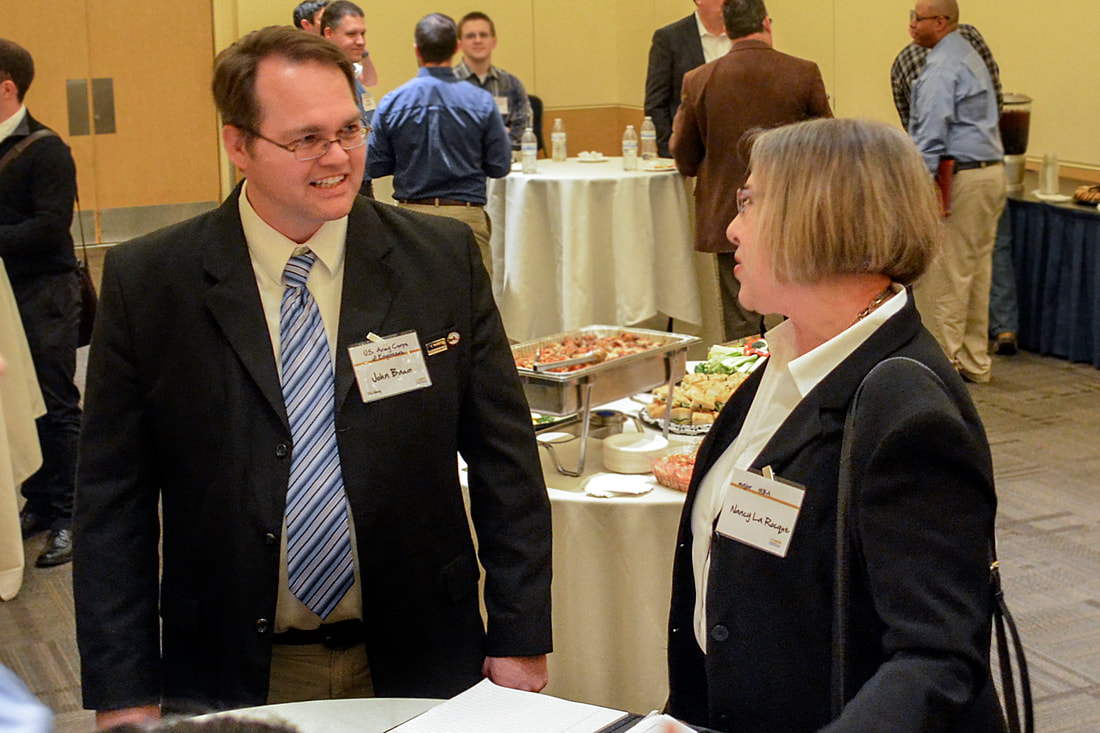 man and woman with name tags talking
