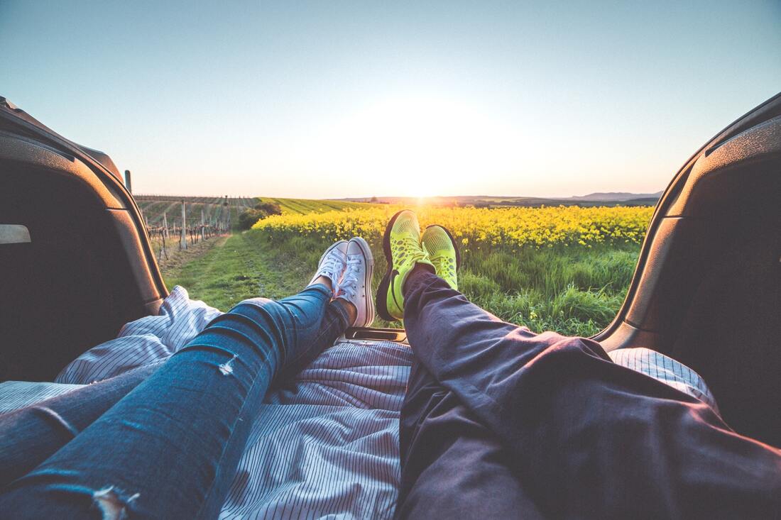 two people lying in the back of a pickup truck 