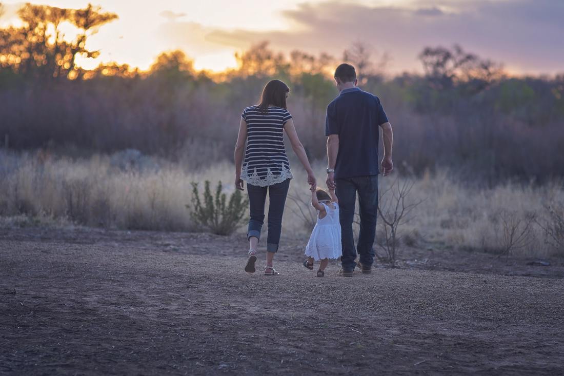 family walking with girl in dress