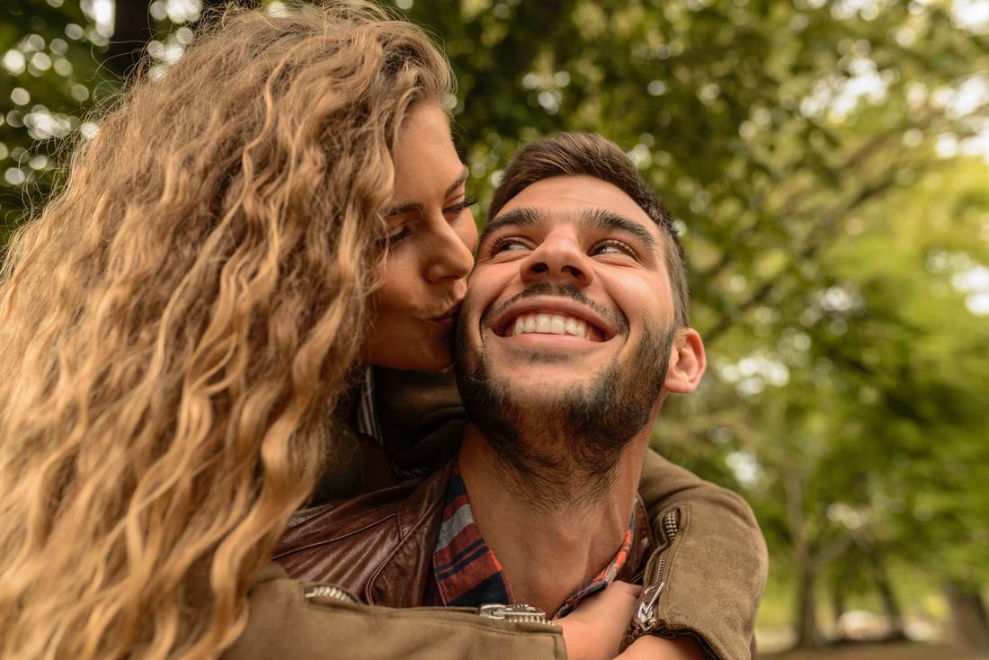 woman kissing man on the cheek