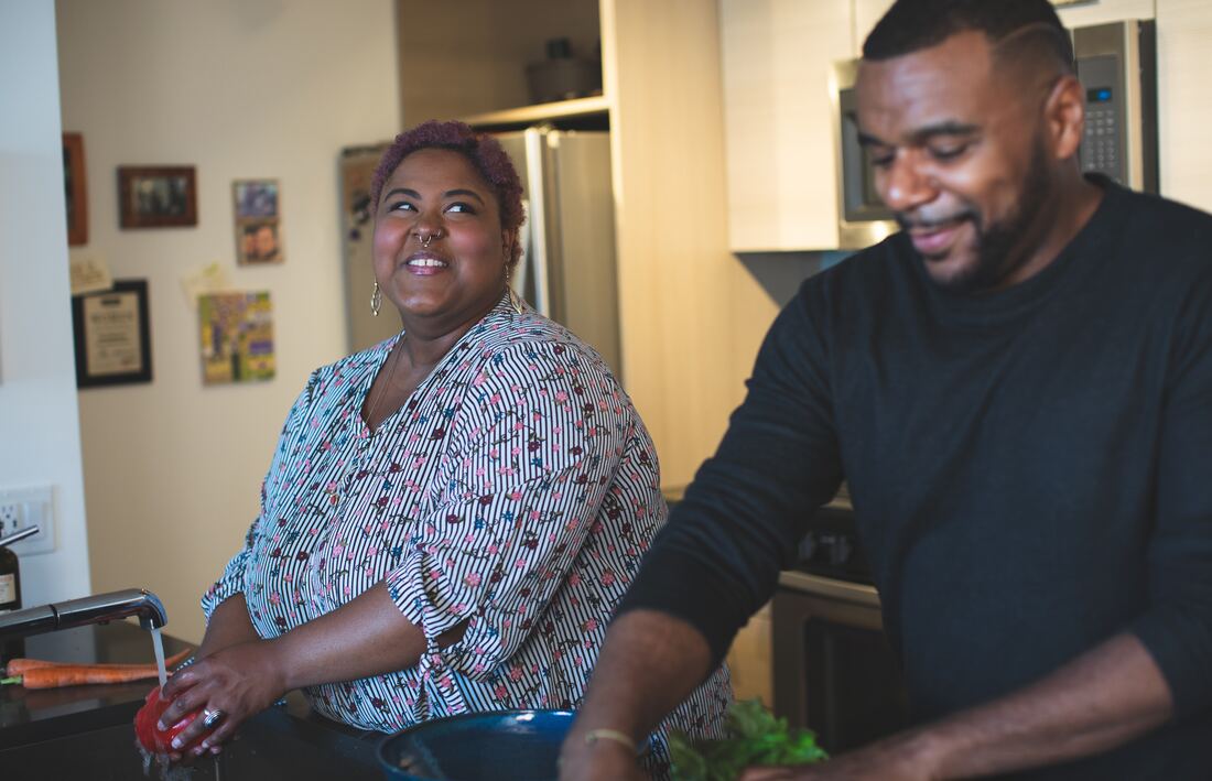 man and woman washing dishes