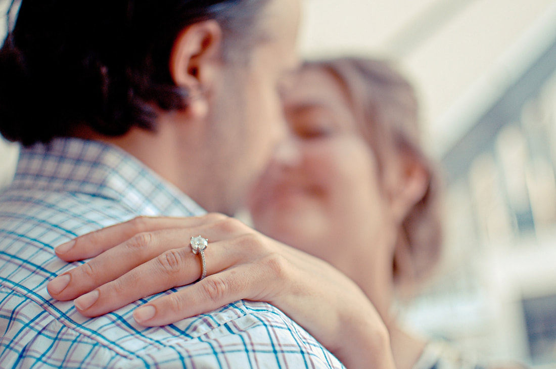 engaged couple showing diamond ring