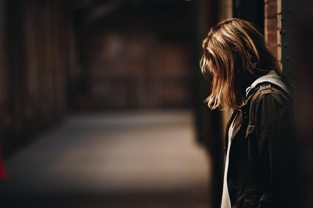 woman leaning against wall