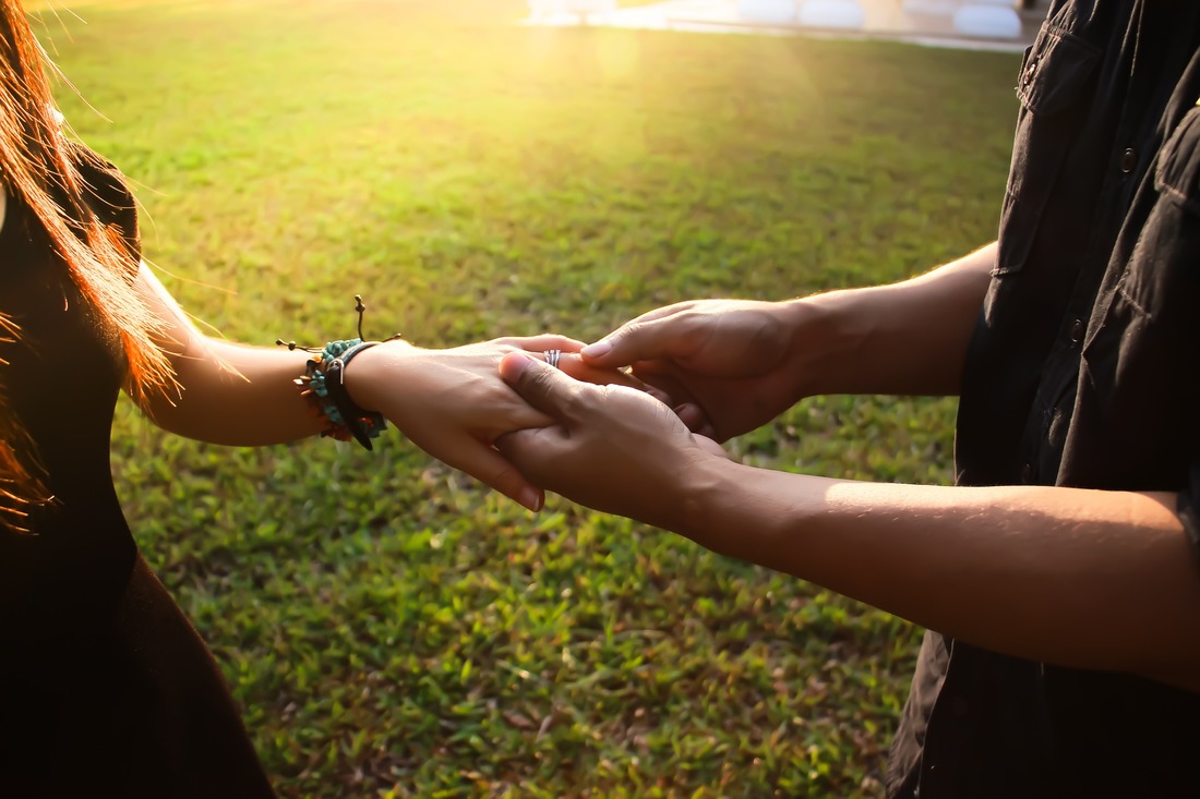 man and woman holding hands 